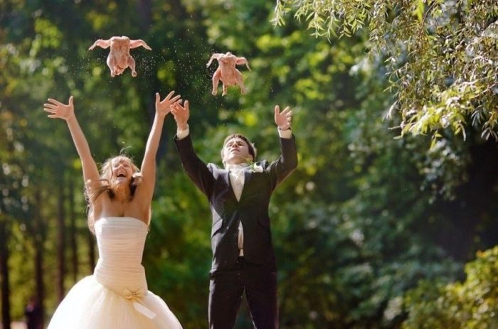 Newlyweds throwing chicken in the air