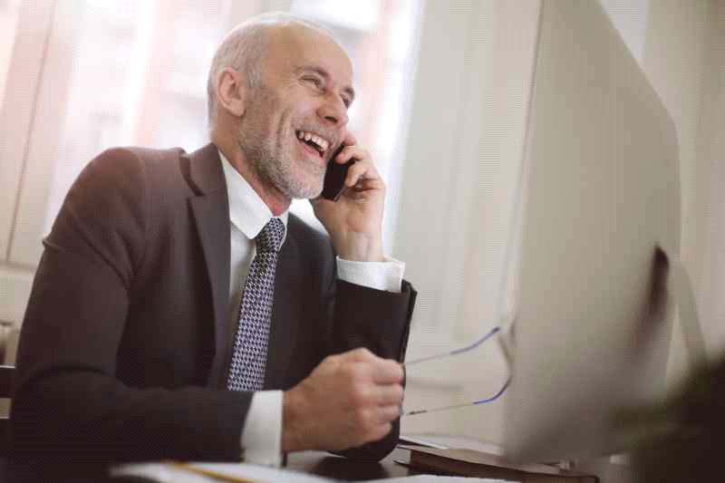 employer laughing and talking on the phone