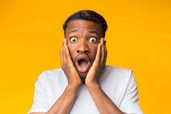 Surprised Black Man Touching Face Posing Over Orange Background - Stock Image - Everypixel